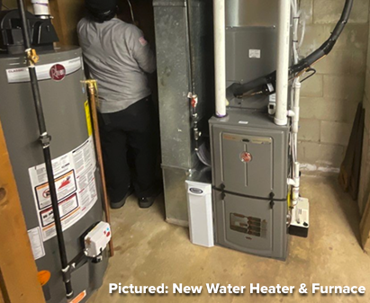 A technician works in a basement near a new water heater and furnace installed against a wall; caption reads, “Pictured: New Water Heater & Furnace.”.